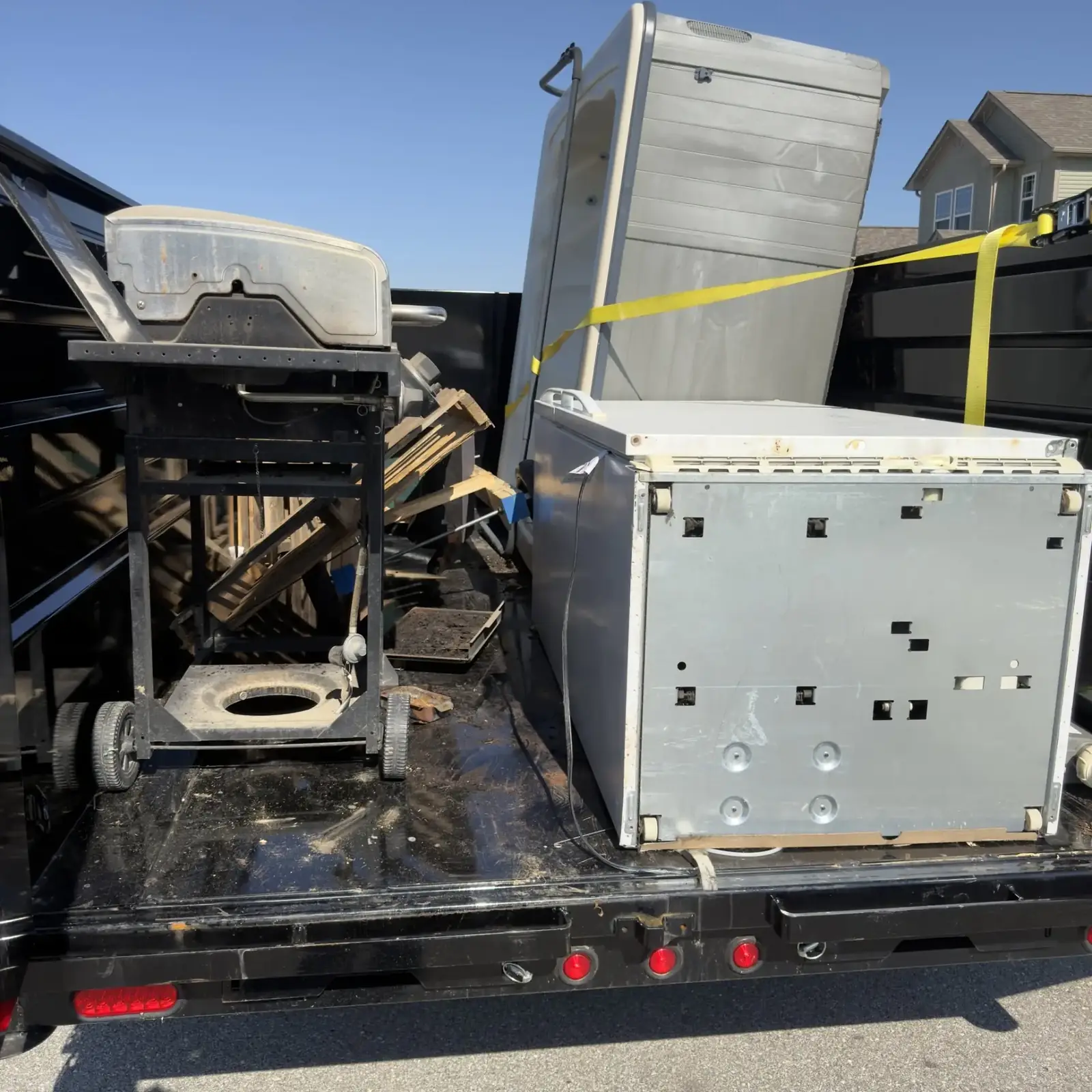 Appliances and debris loaded in the Boone Bros trailer