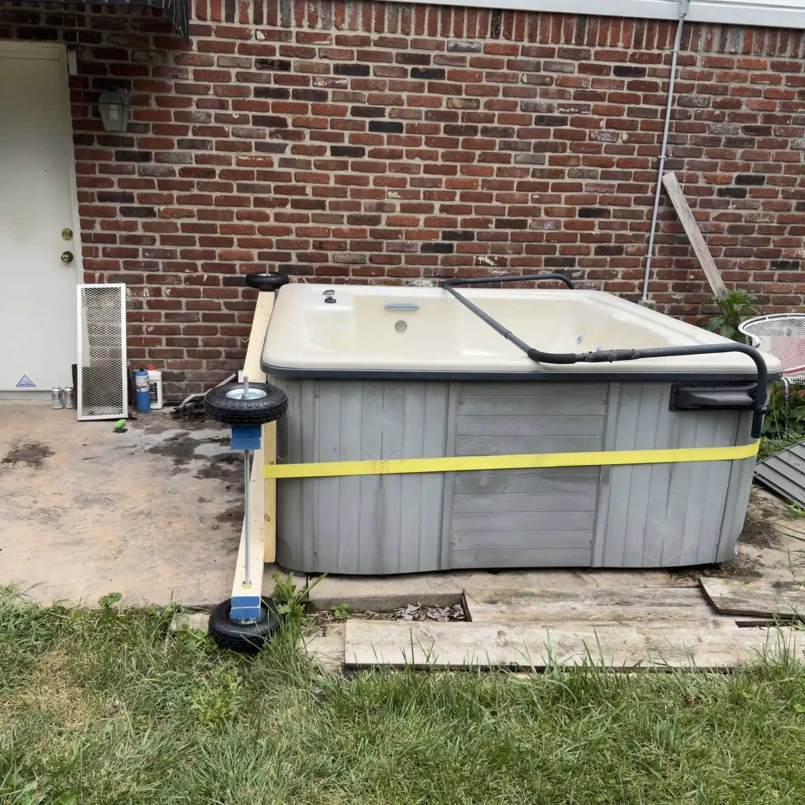 Hot tub strapped and staged for removal